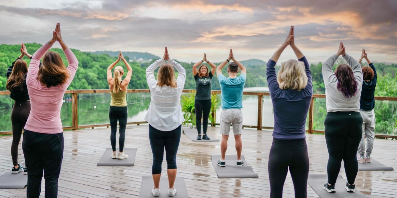 https://www.spasofamerica.com/wp-content/uploads/2023/11/Group-Yoga-Outside-on-Point-Patio-Eagle-Ridge-Resort-Spa-Unveils-New-Group-Wellness-Programs-Healthy-Living-Travel-1280x640.jpeg